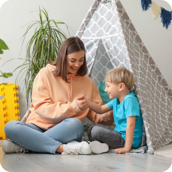 Nanny with child blowing bubbles